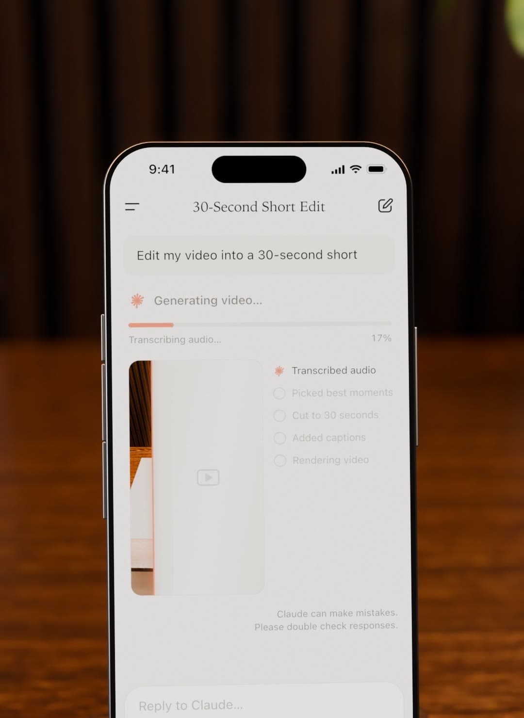 An iPhone in the walnut room showing the Claude app editing a video into a 30-second short, with a progress checklist.