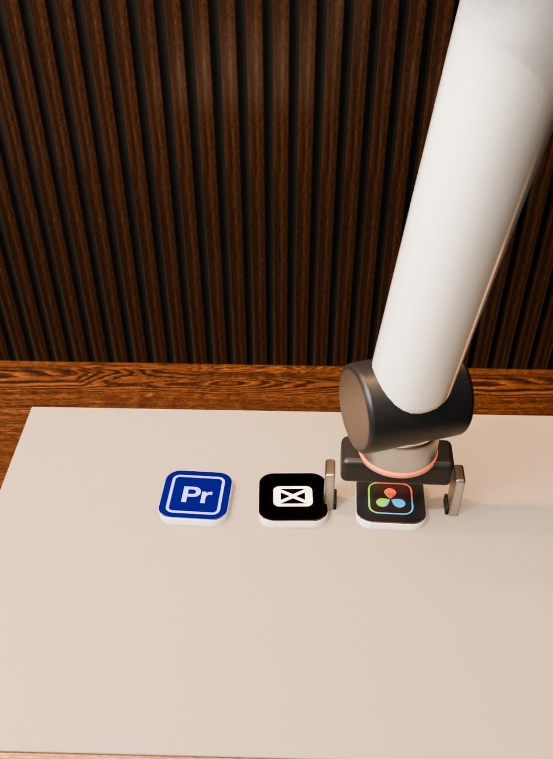 A white robot arm placing app logo tiles (Premiere Pro, CapCut, DaVinci Resolve) on a table.