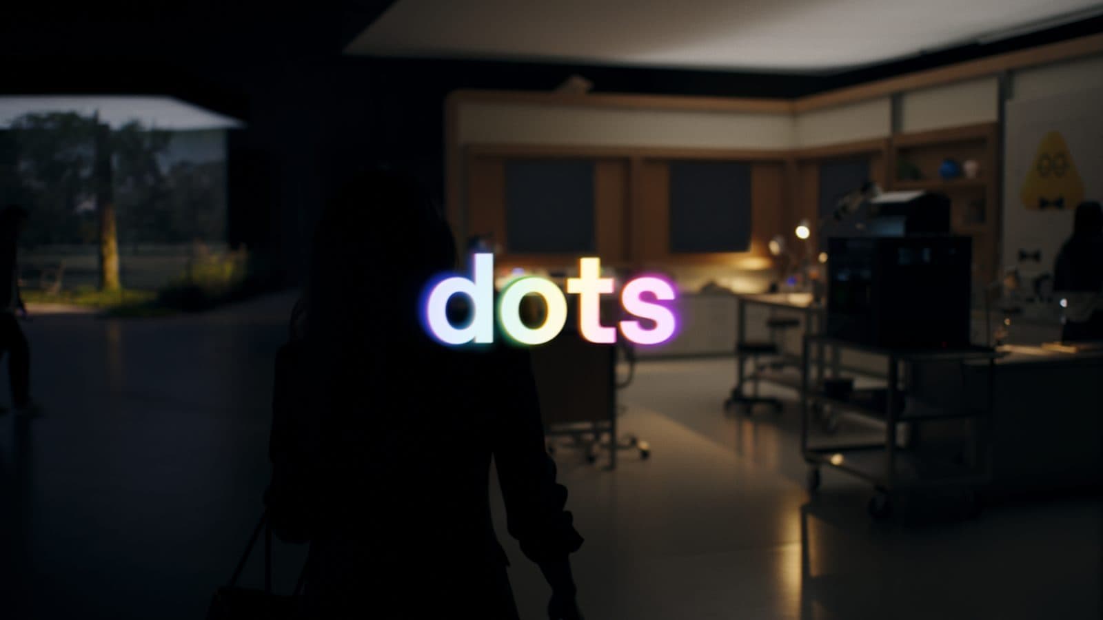 The word dots glowing over a dark studio